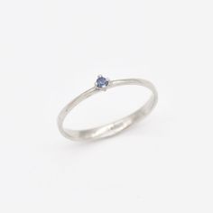 Dainty Sapphire Ring set with Natural Sapphire, size 2 millimetres diameter, 0.03 Carats. Solid 14k White Gold ☞ made to last. Click here for ☞ Solid Gold CollectionSapphire Details:• CERTIFIED Sapphire • Weight: 0.03 Carats• Dimensions: 2 millimeters• Color: Blue• Cut: Round• Origin: BurmaSetting Details:• 1.20 grams of 14k Solid White Gold• Dimensions: Band width ≈ 2.2mm, thickness ≈ 0.7mm• Non-Tarnish - Perfect for Everyday Use - Lasts a Lifetime *Final weight & dimensions depending on the ch Dainty Sapphire Birthstone Promise Ring, Fine Jewelry White Gold Midi Rings, Dainty Sapphire Diamond Ring For Anniversary, Delicate Sterling Silver Rings With Brilliant Cut, Delicate White Gold Birthstone Ring With Round Cut, White Gold Solitaire Midi Rings, Dainty Brilliant Cut Sterling Silver Stackable Rings, Silver 14k Gold Birthstone Ring, Silver 14k Gold Engraved Ring With Birthstone