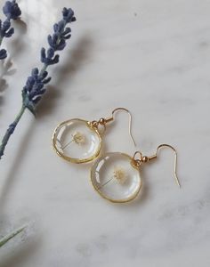 Real pressed white gypsophila earrings preserved in resin in lovely boho style round pendants.  These would make the perfect gift as they come in their own little craft box gift wrapped and can be delivered straight to the door.  The bezels are small and irregular gold or silver circles measuring 2.2cms diameter.  They are on hypoallergenic, gold-plated hooks which are free of nickel and lead (each with a rubber safety back to fix the earring well). May contain some tiny bubbles but they are hardly noticable (see photos). Tiny Resin Crafts, 14k Gold Filled Jewelry As Gift, Minimalist 14k Gold Filled Jewelry With Flower Charm, Metal Jewelry With Flower Charm For Wedding, Handmade Adjustable Rose Gold Jewelry, Adjustable Handmade Rose Gold Jewelry, Dainty Gold-plated Jewelry As A Gift, Dainty Gold Plated Jewelry For Gift, Wedding Jewelry With Metal Flower Charm