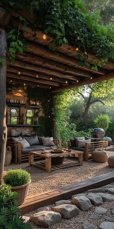 an outdoor living area with couches, tables and potted plants