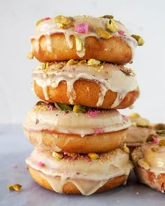 a stack of doughnuts with frosting and sprinkles on them