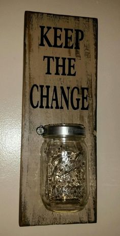 a sign that says keep the change with a mason jar hanging from it's side