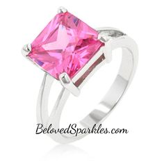 a ring with a pink cubic stone in the center