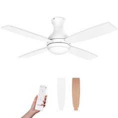 a person holding a remote control in front of a ceiling fan with blades attached to it