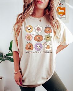 PLEASE NOTE, DUE TO THE BUSY HOLIDAY SEASON ANY ORDERS PLACED AFTER 12/09/24 ARE NOT GUARANTEED TO ARRIVE BY CHRISTMAS.Looking for a comfortable, cute fall shirt that will make you stand out from the crowd? Look no further than our Comfort Colors retro Let's Get Halloweird t-shirt! Give it as a gift to your friends and family this fall season, or wear it yourself to show your support for all things Halloween. Comes in multiple colors! Check out more designs here: www.etsy.com/shop/jadeandrosesho Cute Pre-shrunk Shirt For Fall, Retro Long Sleeve Halloween Tops, Spooky Cartoon Print T-shirt For Fall, Fall Spooky Cartoon Print T-shirt, Fun Fall Tops With Cartoon Print, Retro Tops With Funny Print For Fall, Retro Orange T-shirt For Fall, Retro Fall T-shirt With Funny Print, Pre-shrunk Funny Tops For Fall