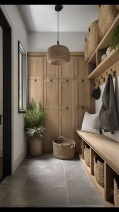 a hallway with wooden shelves and baskets on the wall, along with hanging planters