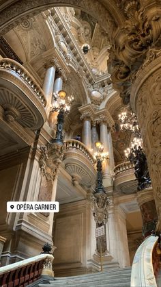 an ornately decorated staircase with chandeliers