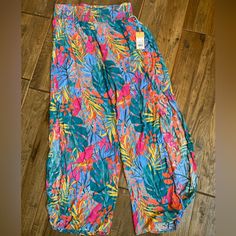 100% Rayon. Slits Up The Sides Of Legs. Waist Is 15, Inseam Is 30 1/2. Vibrant Print Pants For Vacation, Casual Multicolor Harem Pants For Vacation, Casual Orange Jumpsuits And Rompers For Spring, Bohemian Bottoms With Tropical Print For Spring, Casual Beach Bottoms With Vibrant Print, Bohemian Tropical Print Bottoms For Spring, Multicolor Tropical Print Summer Pants, Spring Bottoms With Pockets And Split Shape, Casual Bottoms With Vibrant Print For Vacation