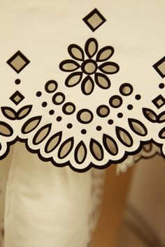 a white table cloth with black designs on it