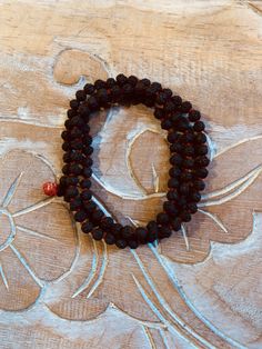 These Rudraksha malas can be worn on wrist or around the neck. Rudraksha beads are known for their healing properties and protective powers. By meditating with a rudraksha mala, it is believed to increase the ability to concentrate, giving clarity and peace of mind. Their size and texture make them great for promoting concentration during meditation.Rudraksha beads are known for their healing properties and protective powers. By meditating with a rudraksha mala, it is believed to increase the ab Traditional Mala With Gemstone Beads For Healing, Red Spiritual Beaded Bracelets For Meditation, Holistic Hand Knotted Jewelry For Rituals, Spiritual Mala With 8mm Beads For Rituals, Traditional Adjustable Mala For Healing, Spiritual Hand Knotted Bracelets With Round Beads, Adjustable Traditional Mala For Healing, Spiritual Healing Mala For Festivals, Healing Spiritual Mala For Festivals