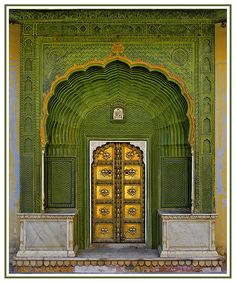 an ornate green building with gold doors