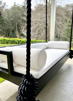 a white couch sitting on top of a swing bed