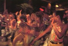 a group of young women dancing in front of a crowd