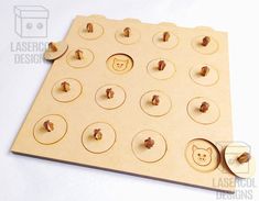 a wooden game board with buttons and holes on the front, showing an image of a teddy bear