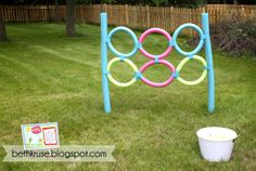 an outdoor game set up in the grass with plastic buckets and toys on the ground