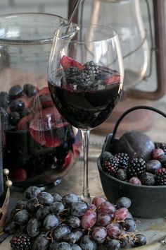 black and white photograph of wine, fruit and kettles