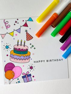 a birthday card with markers and crayons next to it