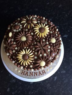 a cake with chocolate frosting and stars on it that says hannah in the center