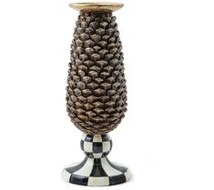 a black and white checkered vase with a pine cone on the top, sitting in front of a white background