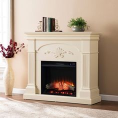 a white fireplace with a fire in it