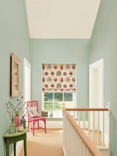 a room with blue walls and pink chairs