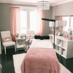 a bed room with a neatly made bed and a chandelier hanging from the ceiling