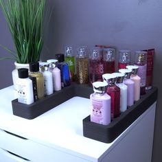 there are many different types of bath products on the shelf in front of the mirror