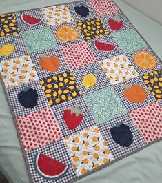 a patchwork quilt with fruit on it