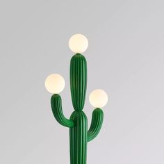 a green cactus lamp sitting on top of a table