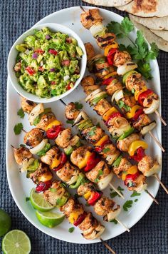 chicken skewers with guacamole, salsa and tortilla chips