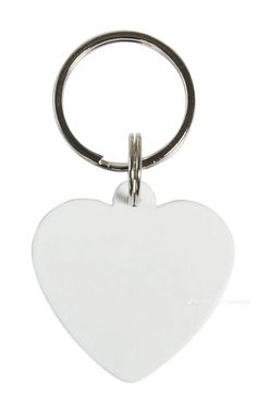 a white heart shaped keychain with a metal ring on the front and back