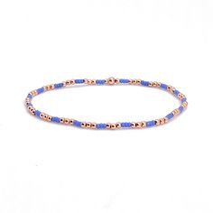 A Solid Statement Band: Flat woven; 1/2"w; 14K yellow/rose gold-filled or sterling silver clasp & 1" extender chain; glass seed beads. Strands: Stretch style; 14K yellow/rose gold-filled or sterling silver round 2mm, 3mm & 4mm beads; glass seed beads. Wrap: Stretch style that will wrap around the wrist 3 times (can also be worn as a necklace); glass seed beads. (When adding to cart, select your single bracelet size, and it will be multiplied in length by three when made). Shown in rose gold; als Adjustable Blue Jewelry With Gold Beads, Blue Bracelets With Gold Beads In Dainty Style, Blue Dainty Bracelets With Gold Beads, Blue Friendship Bracelets With Gold Beads As Gift, Blue Friendship Bracelets With Gold Beads, Dainty Blue Beaded Bracelets With Gold Beads, Dainty Blue Beaded Round Bracelets, Dainty Blue Beaded Bracelets, Blue Jewelry With Gold Beads