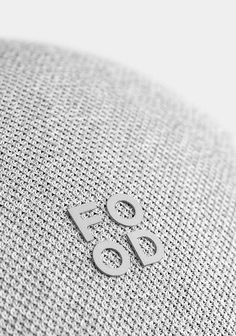 the back side of a white speaker with two silver numbers on it's face