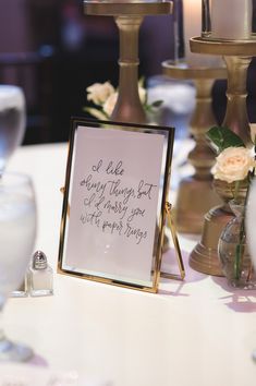 a white table topped with candles and a sign