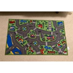 a child's play mat with cars and trucks on it