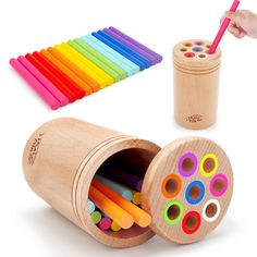 a wooden box filled with colorful crayons and a person holding a toothbrush