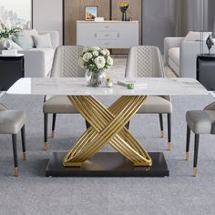 a dining room table with white chairs and a gold cross design on the center piece