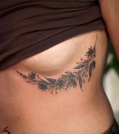 a woman's stomach with flowers and leaves on it