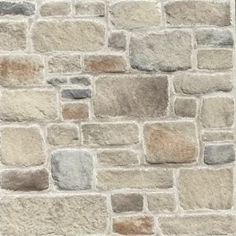 a stone wall with several different colors and shapes