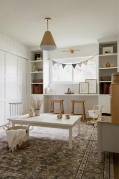 a living room filled with furniture and lots of white shelves on top of each other