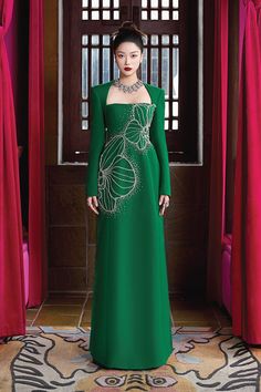 Elevate your style with the luxurious dress. The elegant A-line silhouette and regal Queen Anne neckline exude sophistication, while the soft velvet and smooth satin fabric add a touch of opulence. Make a statement and feel like royalty in this exclusive piece. * Note: The photo of the dress product is sketched based on the ao dai product and is for reference only. Dress products will not have slits on either side. Luxury A-line Evening Dress For Gala, Luxury A-line Gown With Fitted Bodice, Elegant A-line Gala Gown, Elegant Green A-line Gown, Luxury A-line Cocktail Gown, Luxury Silk A-line Evening Dress, Elegant Green A-line Evening Dress, Luxury A-line Dress For Banquet, Luxury Fitted A-line Gown