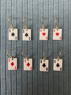 "Ace Playing Card Earrings on gold earring hooks.  Charm Description: Ace playing cards available in four symbols: ace of spades, ace of diamonds, ace of hearts, and ace of clubs. The \"A\" and card symbol for heart and diamond are in red. The \"A\" and card symbol for spade and club are in black. The earring hooks are gold." Playing Cards Earrings, Ace Of Diamonds Accessories, Craft Earrings Ideas, Hazbin Hotel Earrings, Funky Earrings Vintage, Card Costume Diy, Ace Earrings, Ace Playing Card, Playing Card Crafts