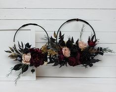 two hoop wreaths decorated with flowers and greenery