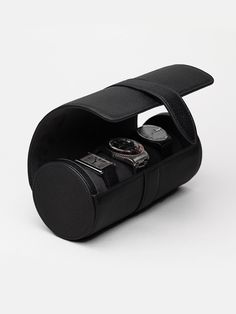 The Watch Roll is the ideal extension for any traveller who enjoys bringing their timepieces on adventures. It has a removable cushion to keep up to three watches safe and secure when on the go or at home. We've included a removable leather divider to avoid any unwanted impact. The elegant case in leather and soft microfiber packs a small size, meaning it easily slips into any bag - big or small.     The watch roll is made by hand in Ubrique, Spain. Black Chronograph Watch For Travel, Black Travel Watch, Black Travel Watches With Round Dial, Black Travel Watch With Round Dial, Modern Black Travel Watch, Travel Watch Accessories With Round Case, Timeless Black Travel Watch, Luxury Black Round Case, Modern Black Watch Accessories For Travel