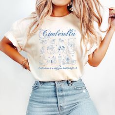 a woman wearing a cinderella shirt and jeans