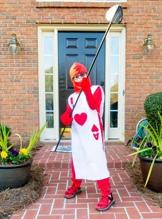 a person in a costume holding a golf club and wearing a heart - shaped outfit