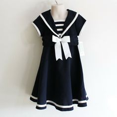 New With Tags Bonnie Jean Sailor Dress Little Girl Size 4 Retail $39.99 This One-Piece Sailor Dress Is Darling. It Is Navy Blue With White Trim And A White Front Bow. It Has An A-Line Skirt And Ties With A Sash In Back. The Dress Has A Zipper Entry. The Dress Is Labeled Size 4 And Is Very Similar To Size 4t. It Is New With Tags. Spring Easter Summer Fall 1940s Sailor Dress, Preppy Navy Cotton Dress, Summer Short Sleeve School Uniform Dress, Summer School Uniform Dress With Short Sleeves, Fitted Short Sleeve School Uniform Dresses, Cute Navy Dress For Dress-up Occasions, Short Sleeve Cotton Dress With Bow, Sailor Style Short Sleeve Fitted Dress, Cute Navy Short Sleeve Dress