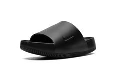 The Nike Calm Slide "Black" is a versatile, monochromatic black colorway of the comfortable slip-on sandal.  Designed for post activity wear, the Calm Slide debuted in 2023 in several appealing colorways, including in this easy-to-style “Black” design.  The sandal is constructed from a black one-piece foam mold.  The midfoot strap that supports the sandal features a debossed Swoosh on the side.  Underneath, a thick foam cushioning footbed provides a comfortable ride. Black One Piece, The Calm, Slide In, All Brands, Black Design, Nike Logo, Slip On Sandal, Luxury Branding, Black Shoes