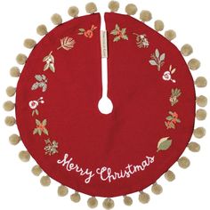 a red christmas tree skirt with pom - poms around the bottom and merry christmas written on it