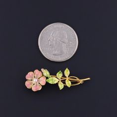 This antique 14k gold brooch (circa 1910) features a pink enamel flower with a pearl accent at its center and iridescent green enamel leaves. The piece bears the maker's mark for the renowned Krementz & Co. of Newark, NJ. The brooch measures 0.5 inches by 1.5 inches wide. It is in very good condition with some minor wear to the enamel on the periphery of one petal (visible only under very close inspection). We have many other fine jewelry items and antique conversion pieces on our Etsy store, so Elegant Flower Enamel Pin Collectible, Collectible Gold Flower Enamel Pin, Formal Flower-shaped Enamel Brooches, Formal Flower Enamel Brooches, Newark Nj, Iridescent Green, Gold Brooch, Pink Enamel, Gold Brooches