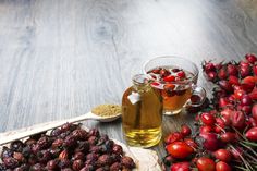 a wooden table topped with lots of different types of fruit and vegetables next to a cup of tea